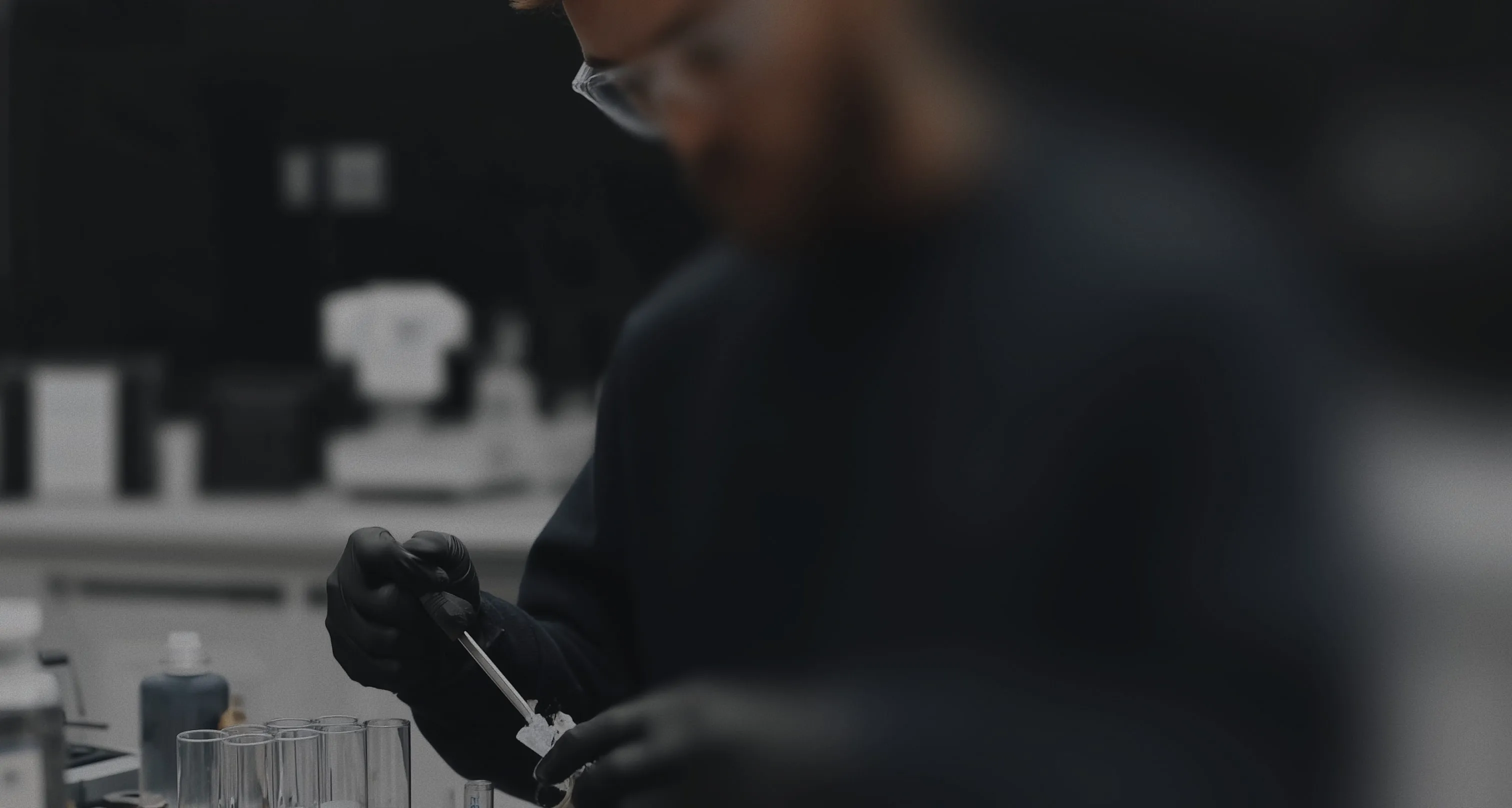 A man in a black shirt is doing something.